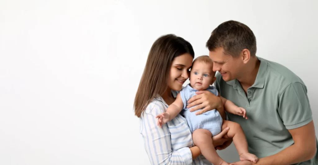 Mother and father holding a baby