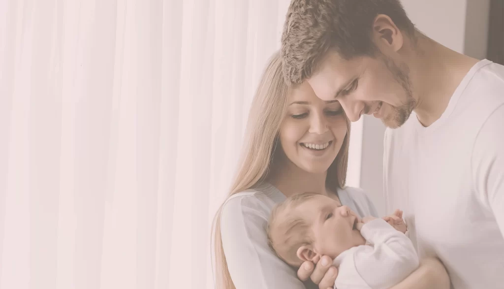 Mother and Father holding a baby